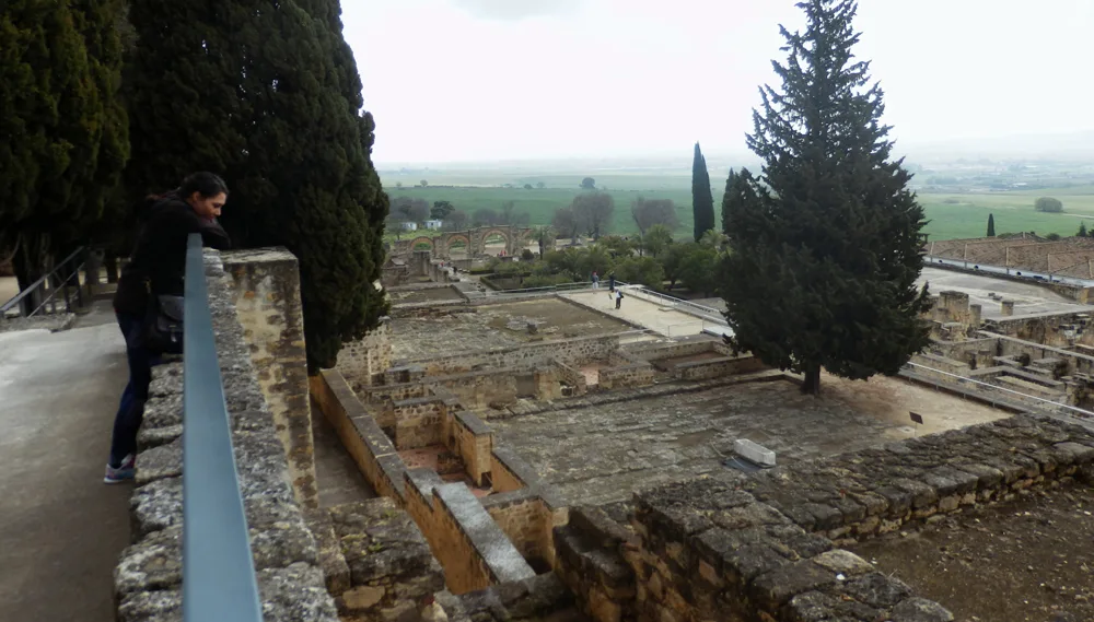View of Medina Azahara, Córdoba, Spain. The image captures the ruins of the 10th-century Islamic palace-city, built during the reign of Caliph Abd al-Rahman III. Stone arches, column remnants, and decorative carvings showcase the architectural grandeur of Al-Andalus. 