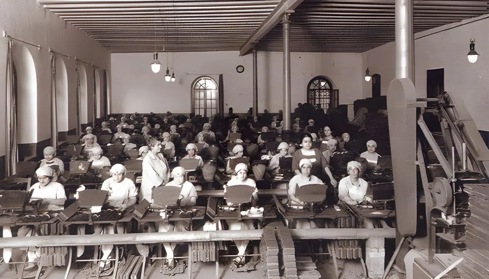 Cigarreras working at the Tabacalera in Lavapiés, Madrid, Spain, c. 1910. The image depicts women engaged in cigar-making, a significant part of Madrid's industrial and social history.