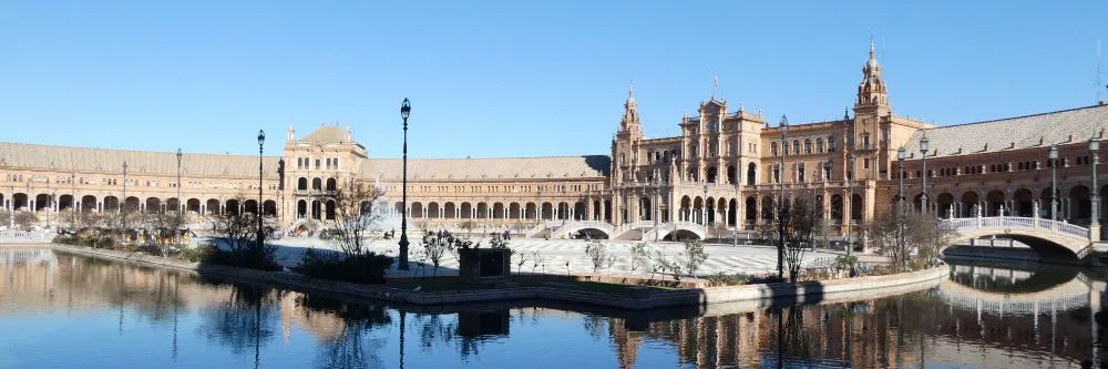 Sweeping Elegance: The Plaza de España in Seville unfurls in a stunning embrace, a testament to the grandeur of Spanish Renaissance Revival architecture.