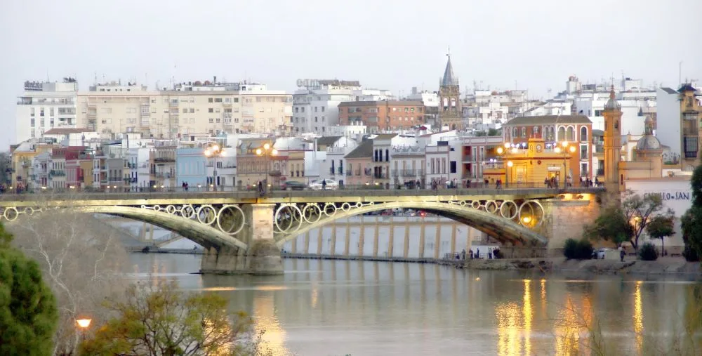 Triana's Charm: Stroll through the vibrant streets of Seville's Triana district, where flamenco rhythms pulse through the air and the spirit of old Sevilla is painted in every colorful tile and lively plaza.