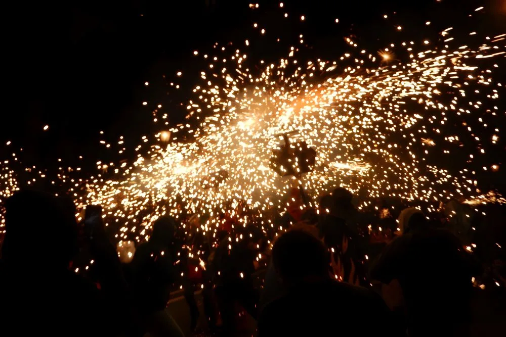 Experience the fiery spectacle of Correfoc on Via Laietana, a thrilling highlight of the free La Mercè celebrations in Barcelona.