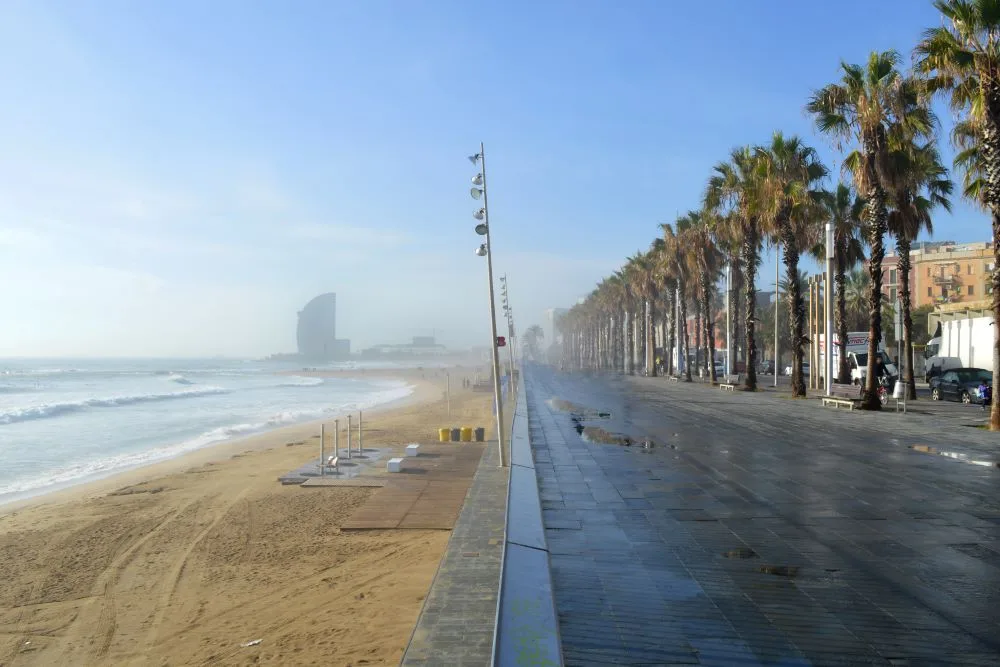 On the sandy shores of Platja de la Barceloneta, a beloved beachside escape among Barcelona's free attractions