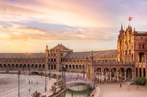 "Panoramic Splendor: Seville's Plaza de EspaÃ±a, a majestic semi-circular marvel of architecture, embraces the Andalusian spirit under the Iberian sun.