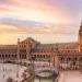 "Panoramic Splendor: Seville's Plaza de España, a majestic semi-circular marvel of architecture, embraces the Andalusian spirit under the Iberian sun.