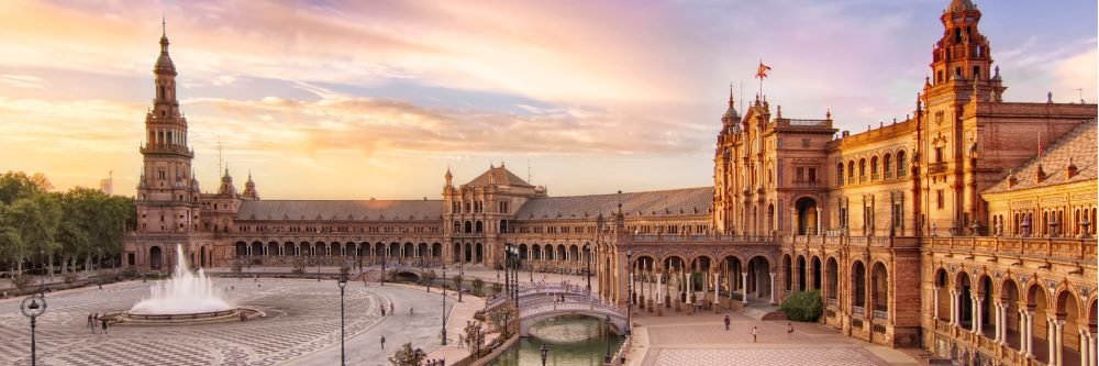 "Panoramic Splendor: Seville's Plaza de España, a majestic semi-circular marvel of architecture, embraces the Andalusian spirit under the Iberian sun.