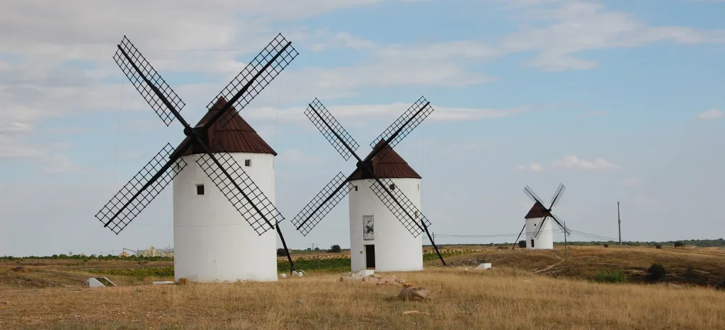 Windmills against the horizon, Mota del Cuervo's silhouettes whisper tales of Don Quixote's timeless Spain