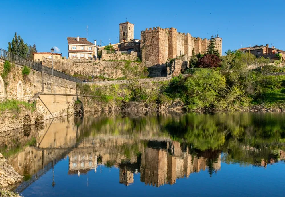 Medieval Splendor: The Alcazar of Buitrago del Lozoya Overlooking the Tranquil Waters