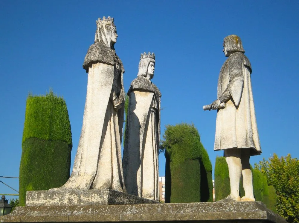 Statues of the Catholic Monarchs and Columbus, Alcázar of the Christian Monarchs, Córdoba, Spain [Edited Photograph]. Credit: Pablo Rodríguez Madroño. Licensed under CC BY-SA 2.0. 