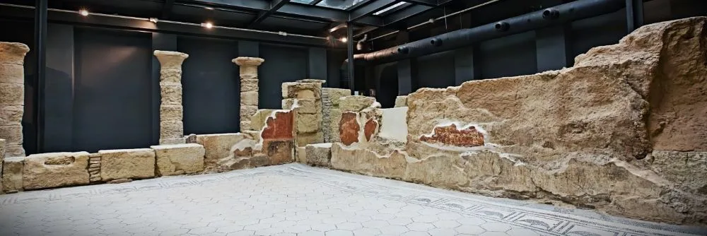 Roman Domus at Hotel Hospes Palacio del Bailío: A 1st-century house with a preserved mosaic in its peristyle and two rooms featuring rammed earth walls and painted decorations.