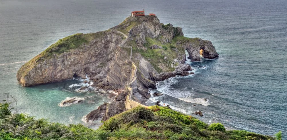 Gaztelugatxe, Connected to the Coast by a Pedestrian Bridge [Photograph]. Credit: Ángel M. Felicísimo. Originally published on Flickr. Licensed under Creative Commons Attribution 2.0 Generic license.