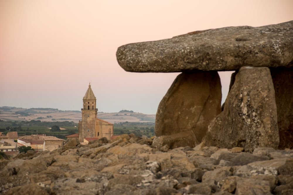 Church of the Assumption and Dolmen of Sorginaren Txabola, Bilar (Elvillar, Spain) [Photograph]. Credit: Theklan. Licensed under CC BY-SA 4.0.